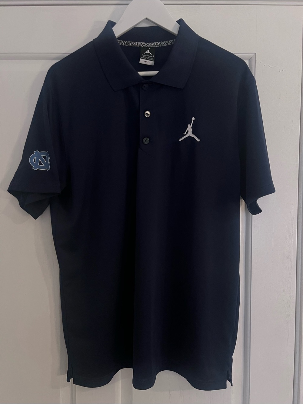 Jordan Men's Navy Polo with White Jumpman and UNC Blue Sleeve Logo